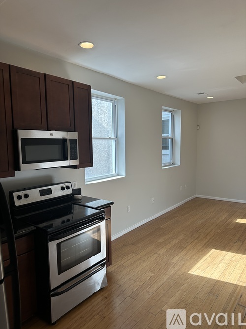 A kitchen with a stove top oven and microwave.