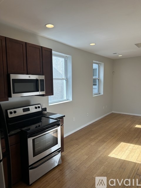 A kitchen with a stove top oven and microwave.