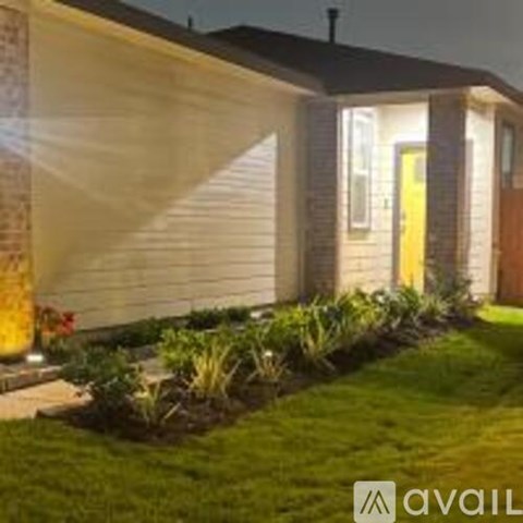 A house with a yellow door and a well-maintained lawn.