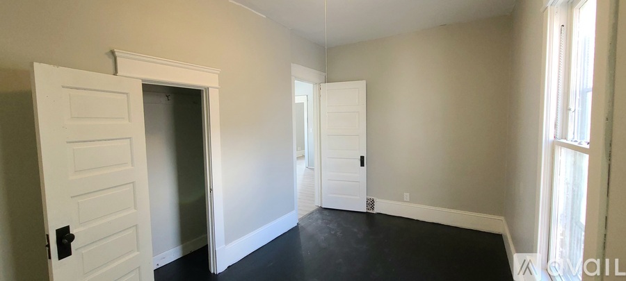 A room with a white door and a window.