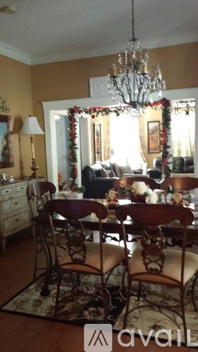 A dining room with a table set for four.