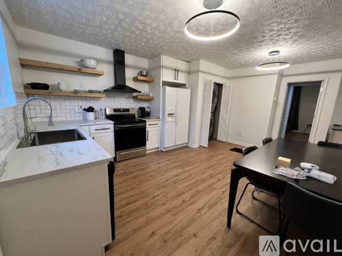 A kitchen with a white countertop and a black stove top oven.