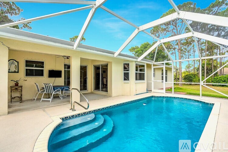 A pool in a house with a white roof.