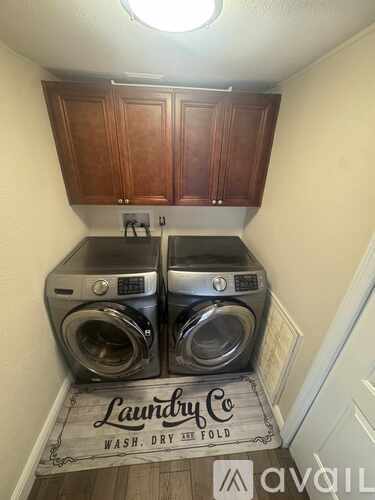 Two front loading washing machines in a laundry room.