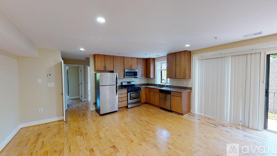 A kitchen with wooden floors and a refrigerator.