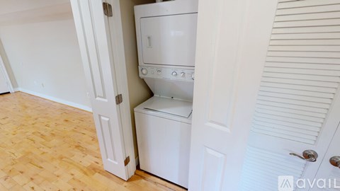 A white dishwasher is built into a white cabinet in a kitchen.