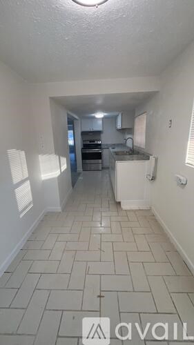 A kitchen area with a counter and cabinets.