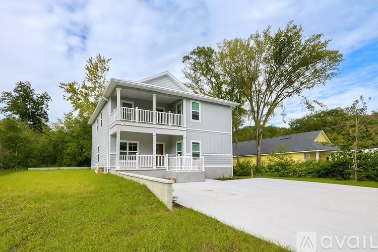 A two-story house with a balcony and a porch.