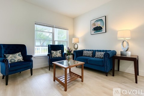 A living room with blue furniture and a wooden coffee table.