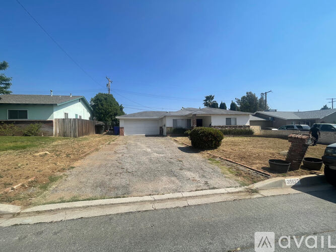 A residential area with a house and a driveway.