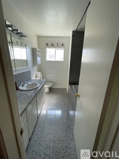 A bathroom with a toilet, sink, and bathtub.
