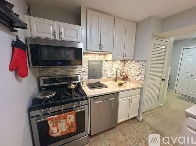 A kitchen with a stove top oven and microwave.