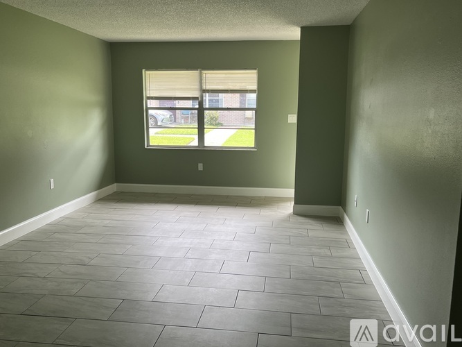 Empty room with tiled floor and a window.