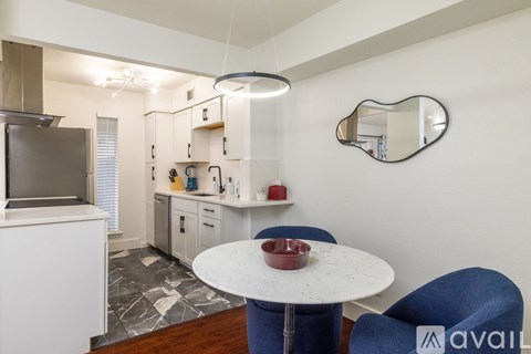 A kitchen with a table and a blue chair.