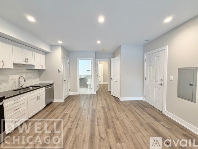 A room with wooden flooring and a white door.
