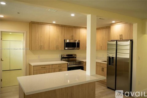 A kitchen with wooden cabinets and a white countertop.
