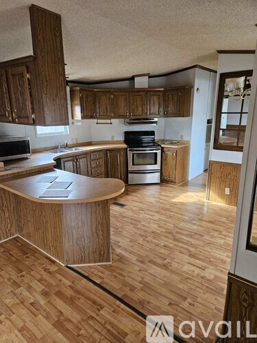 A kitchen with wooden cabinets and a wooden island.