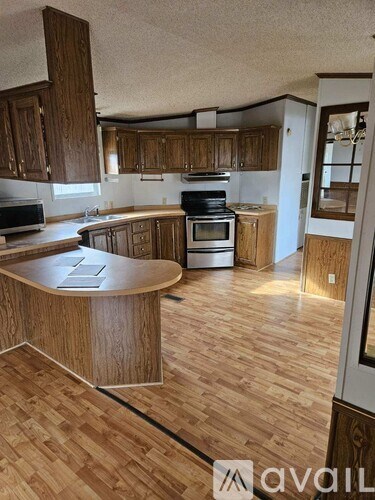 A kitchen with wooden cabinets and a wooden island.