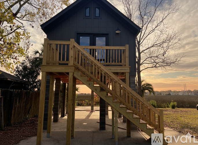 A wooden deck leads up to a house.