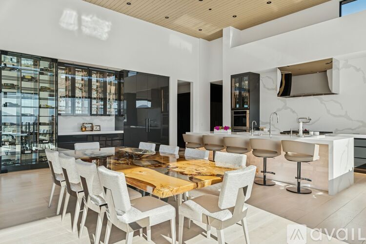 A modern kitchen with a dining table and chairs.