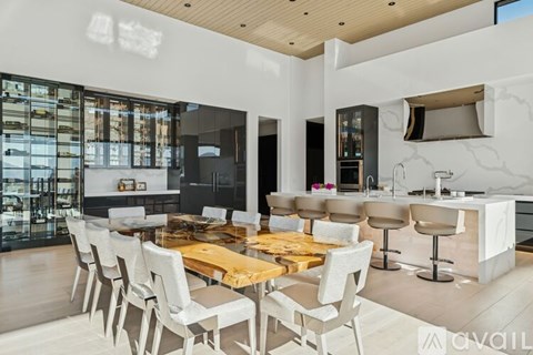 A modern kitchen with a dining table and chairs.