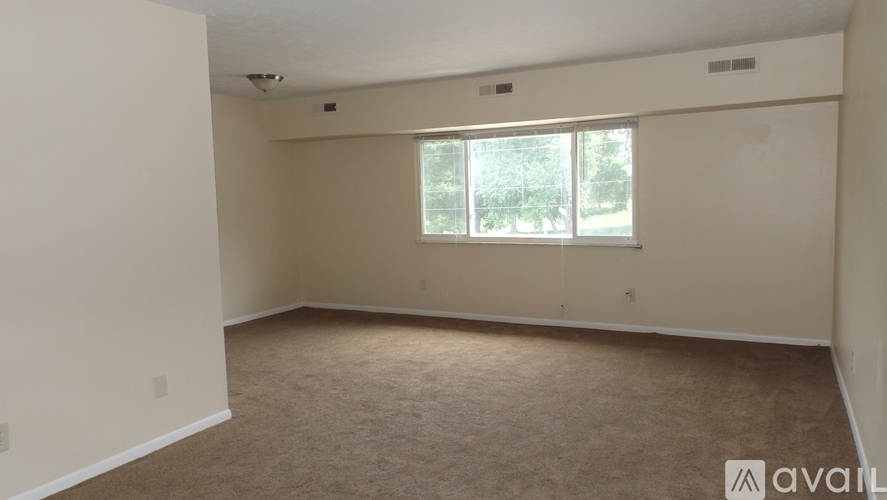 Empty room with carpeted floor and a window.