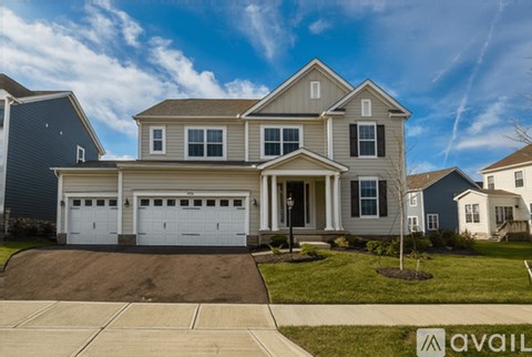 A large house with a driveway in front of it.