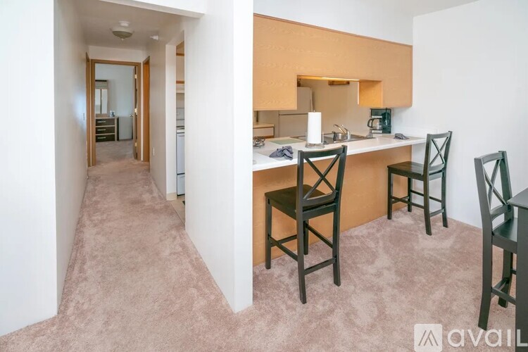 A kitchen area with a table and chairs.