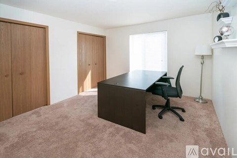 A room with a desk and a chair.