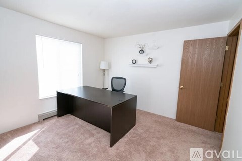 A room with a desk and a window.