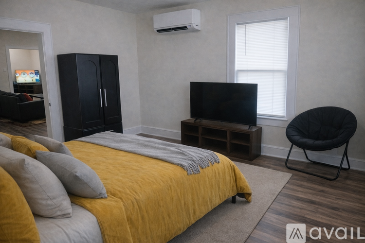 A kitchen with brown cabinets and a black fridge.