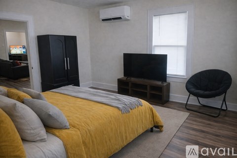 A kitchen with brown cabinets and a black fridge.