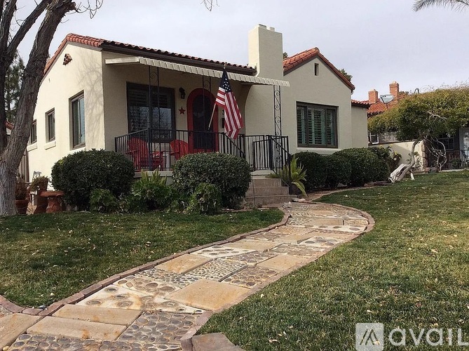 A house with a flag on the front porch.