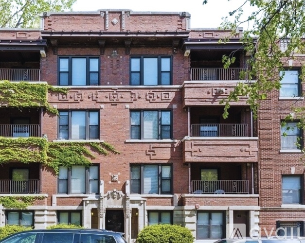 A red brick building with balconies and windows.