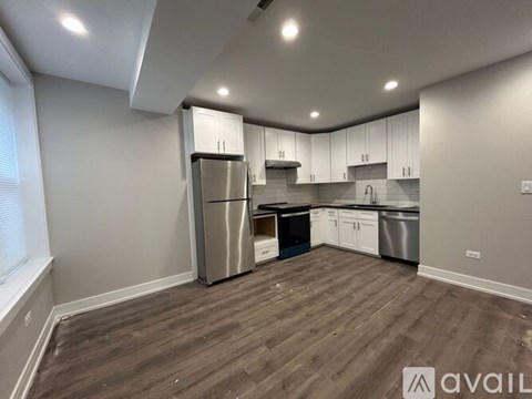 A kitchen with wooden floors and stainless steel appliances.
