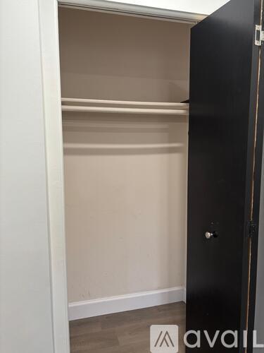 A kitchen with a refrigerator, sink, and cabinets.
