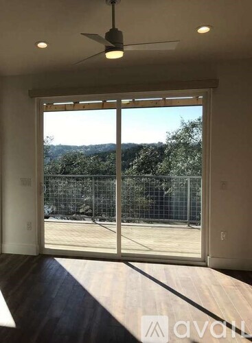 A room with a sliding glass door leading to a backyard.