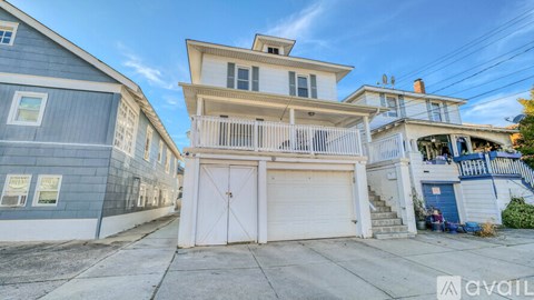 A two-story house with a white garage door.