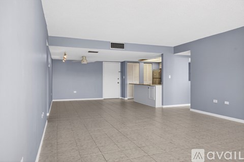 A room with a ceiling fan and a door.