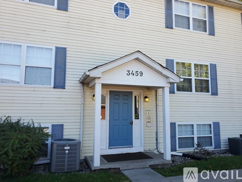 A house numbered 3459 with a blue door and a small porch.
