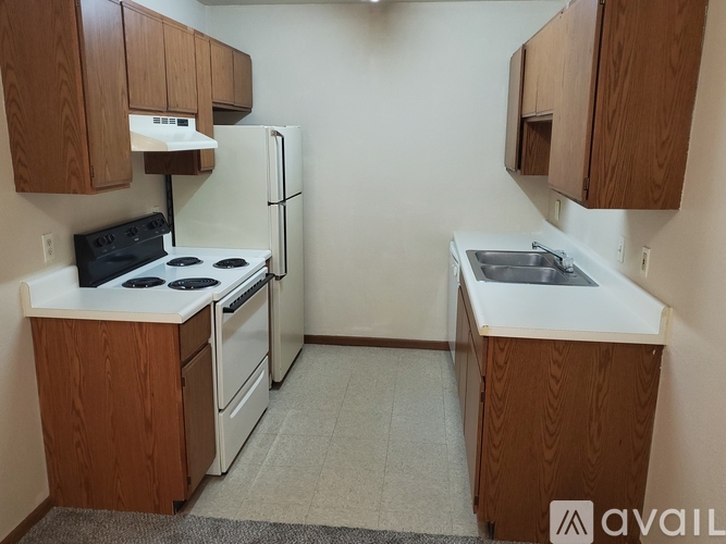 A kitchen with a stove, oven, and sink.