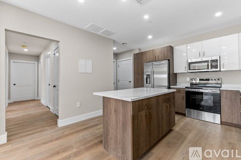 A modern kitchen with wooden cabinets and stainless steel appliances.