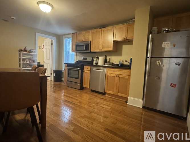 A kitchen with wooden cabinets and a refrigerator.