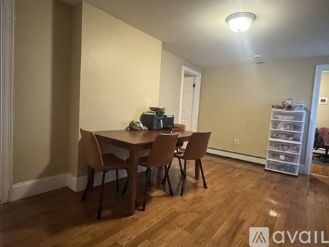 A dining room with a table and chairs.
