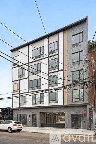 A modern building with a car parked in front.