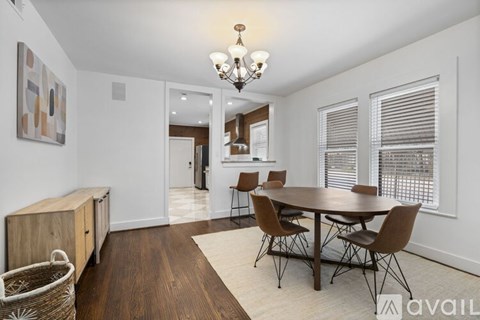 A dining room with a wooden table and chairs.