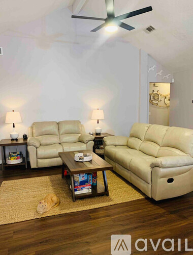 A living room with a white couch and a coffee table.