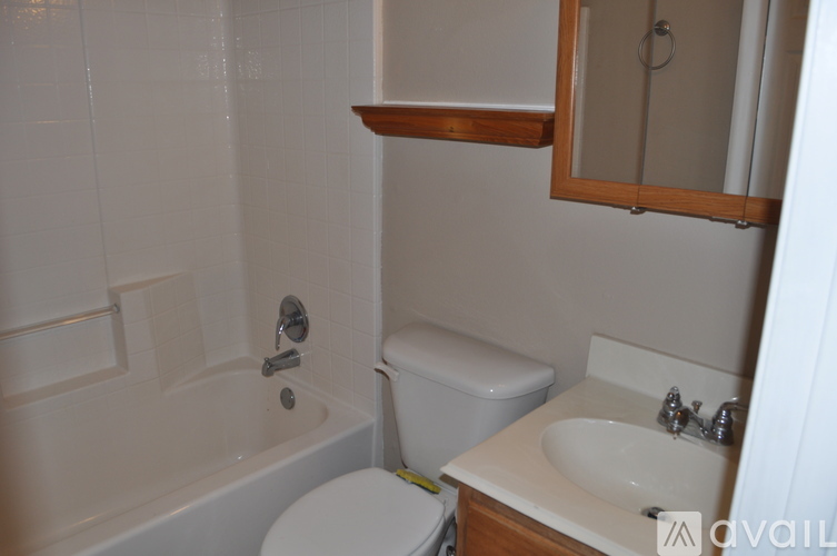 A white toilet sits next to a sink in a small bathroom.