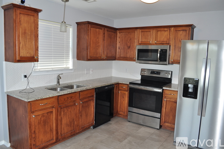 A kitchen with wooden cabinets and stainless steel appliances.