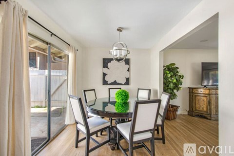 A dining room with a glass table and chairs.
